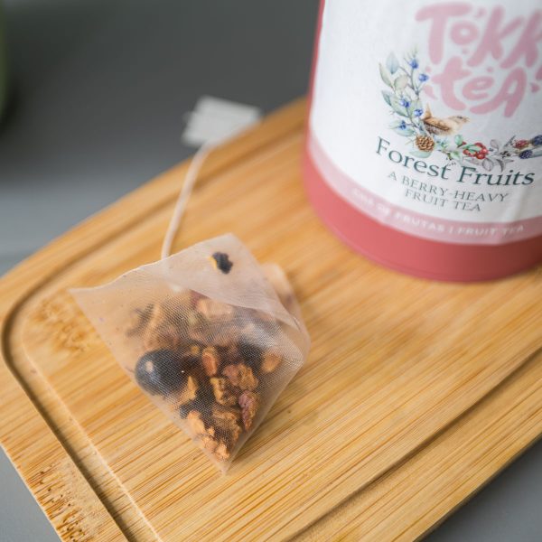 Forest Fruits organic fruit tea in pyramid bags with a pink tin by Tokki Tea Portugal