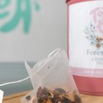 Forest Fruits organic fruit tea in pyramid bags with a pink tin by Tokki Tea Portugal